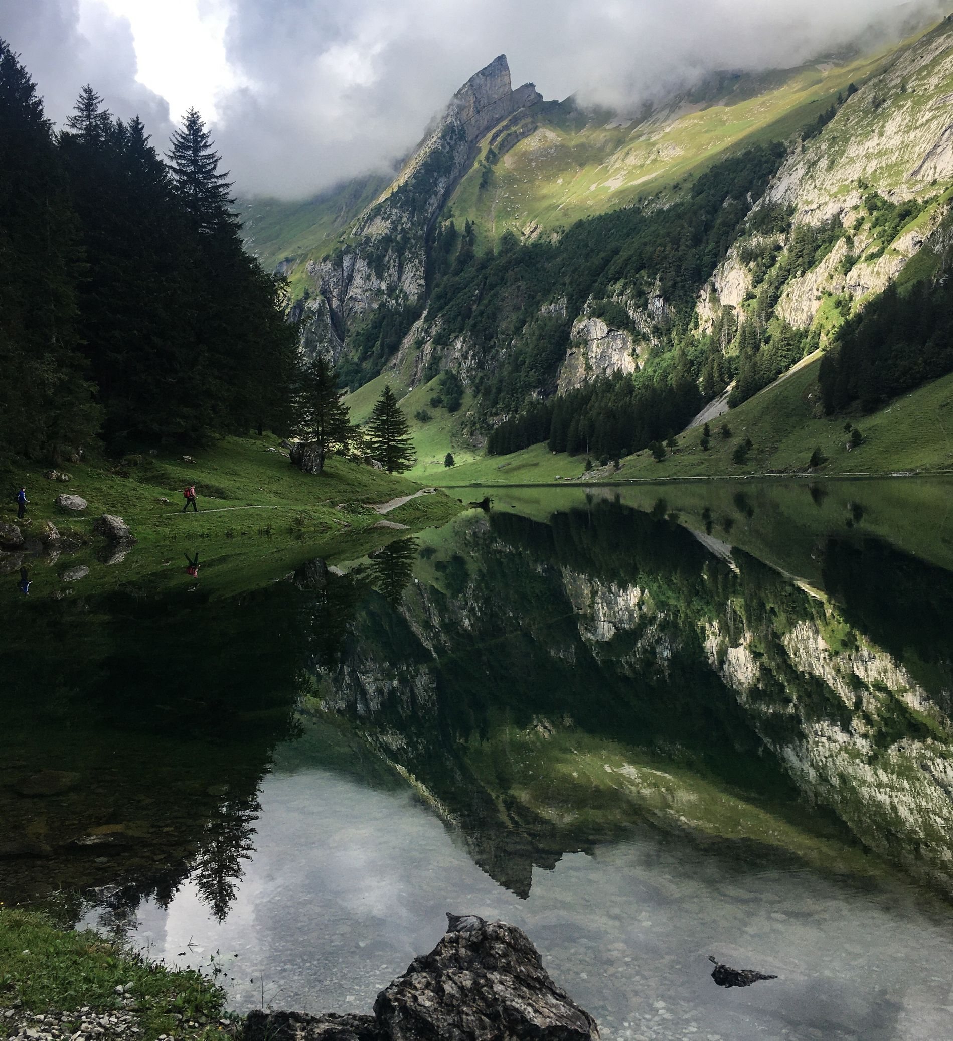 Still alpine lake reflecting the mountains at Seealpsee